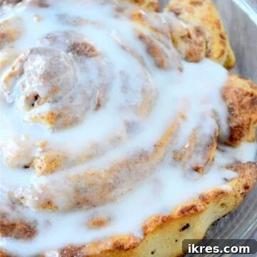 A giant fluffy cinnamon roll covered in cream cheese icing.