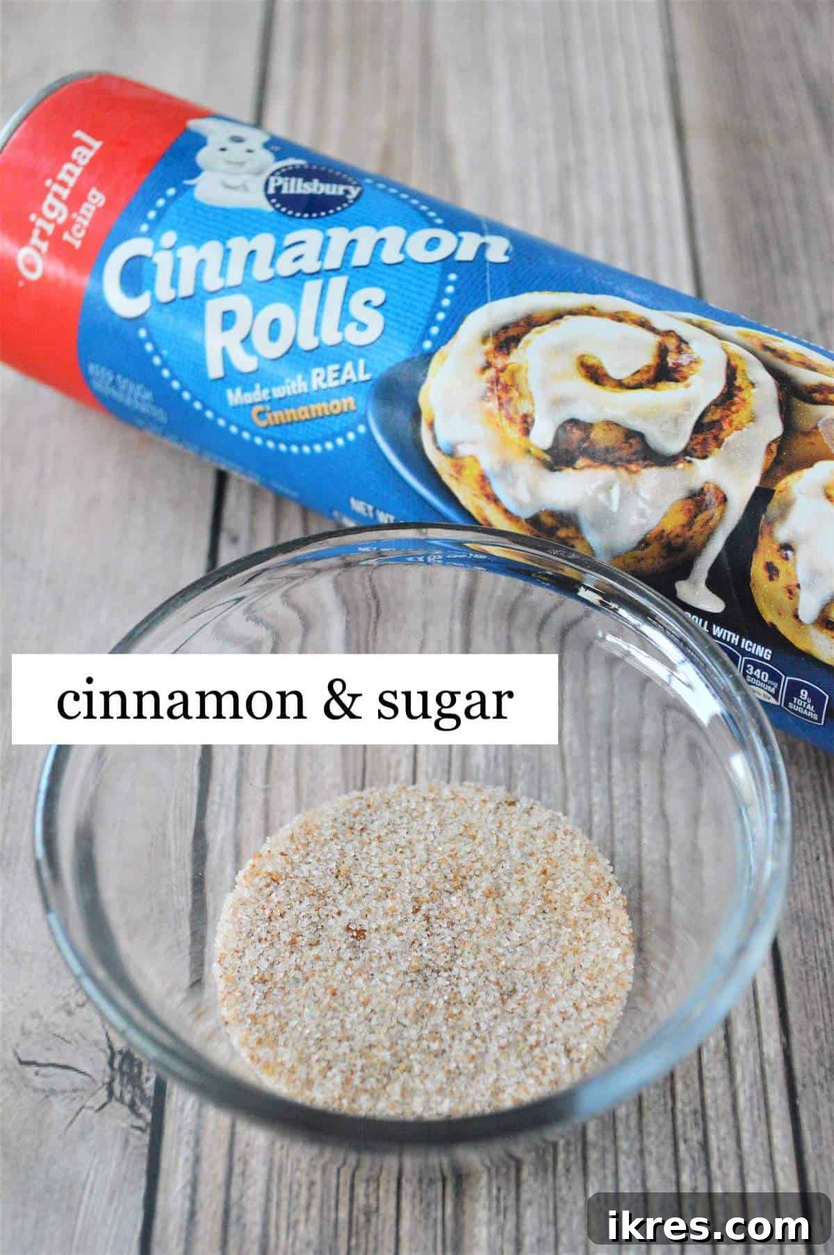 The simple ingredients for a giant cinnamon roll, including canned dough, sugar, and cinnamon, neatly laid out.