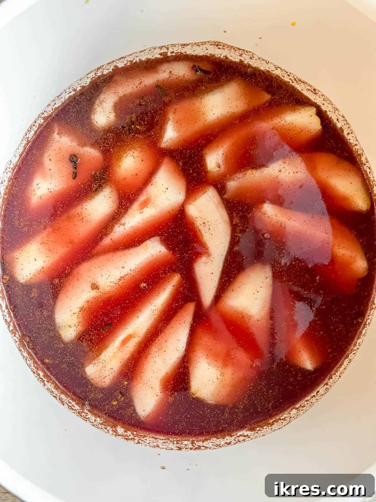 Crimson Pears with Zesty Spice Infusion 8 Red wine being added to the pan with pears and orange juice, along with orange zest.