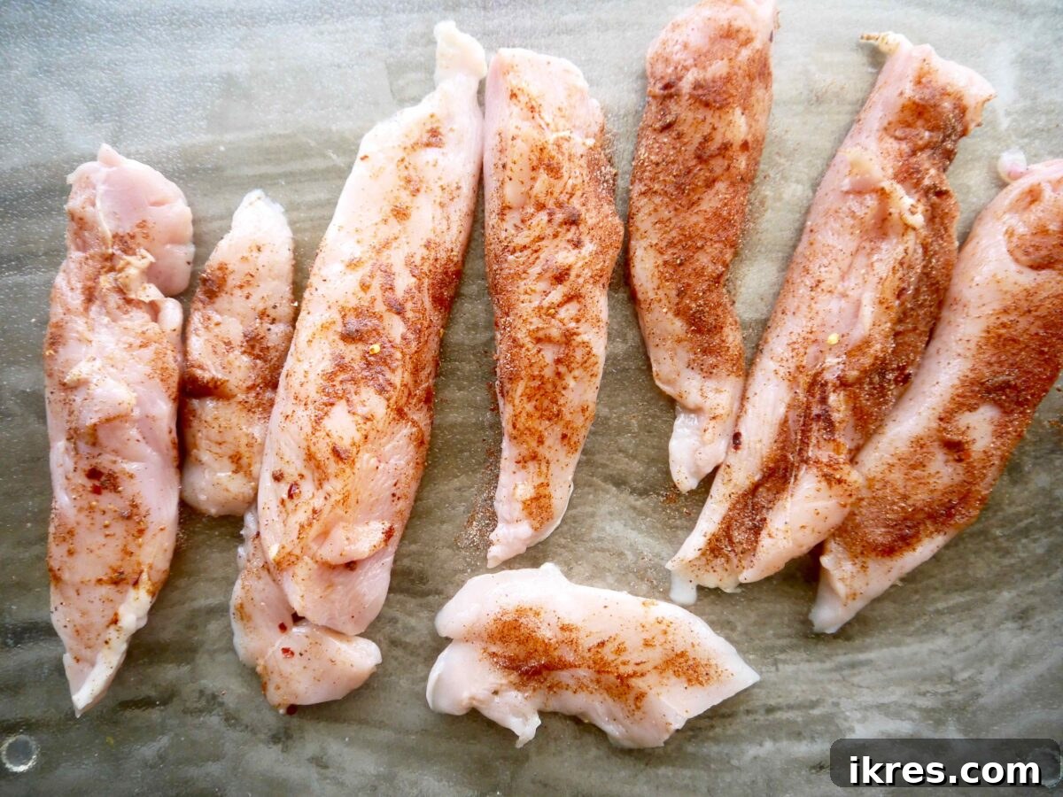 Guilt Free Paleo Keto Bacon Wrapped Chicken Tenders 5 Raw chicken tenders generously coated with a savory seasoning blend.