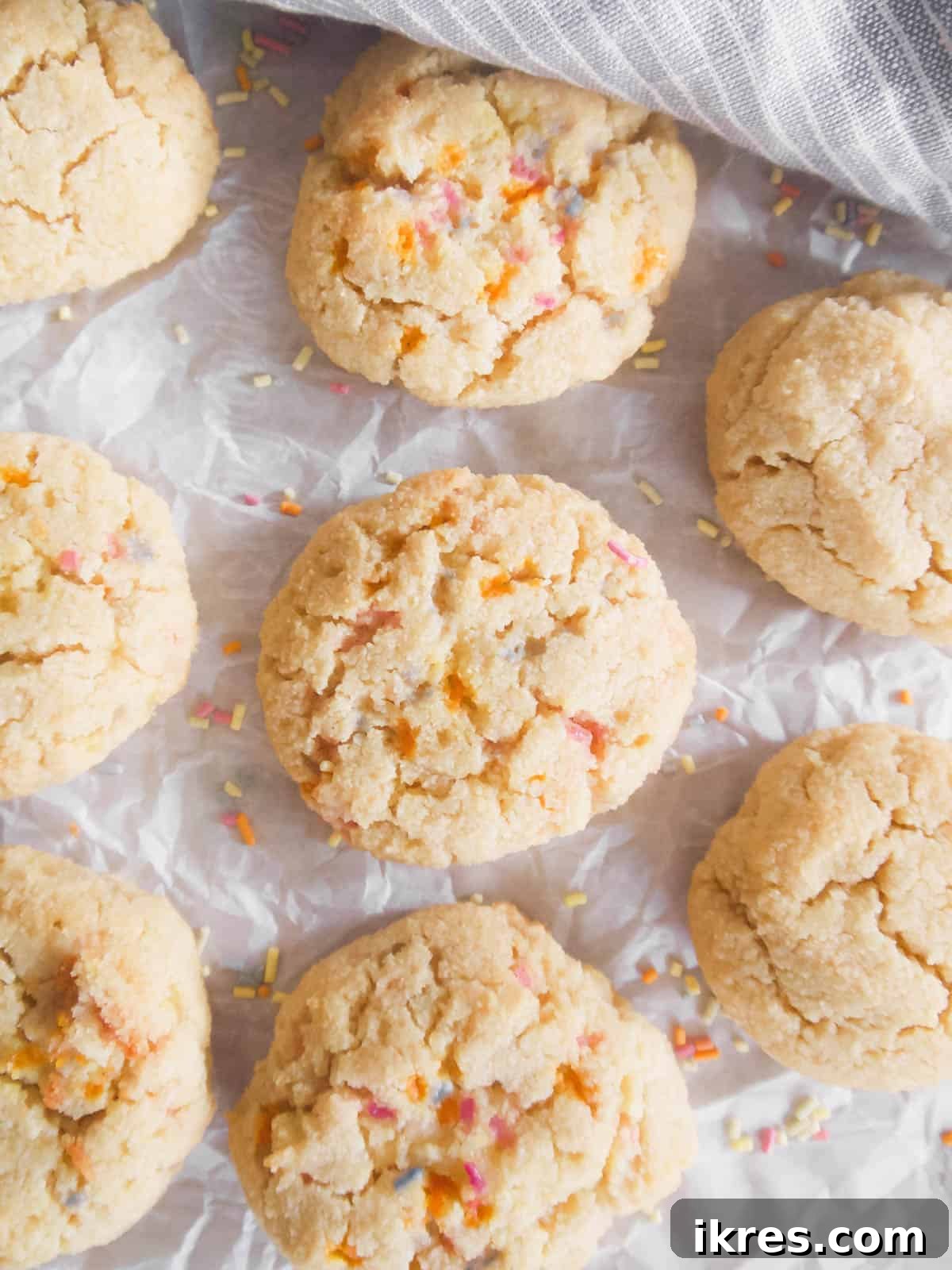 Delicious Paleo and Gluten Free Sugar Cookies 5 Paleo sugar cookies freshly baked on a parchment-lined tray.