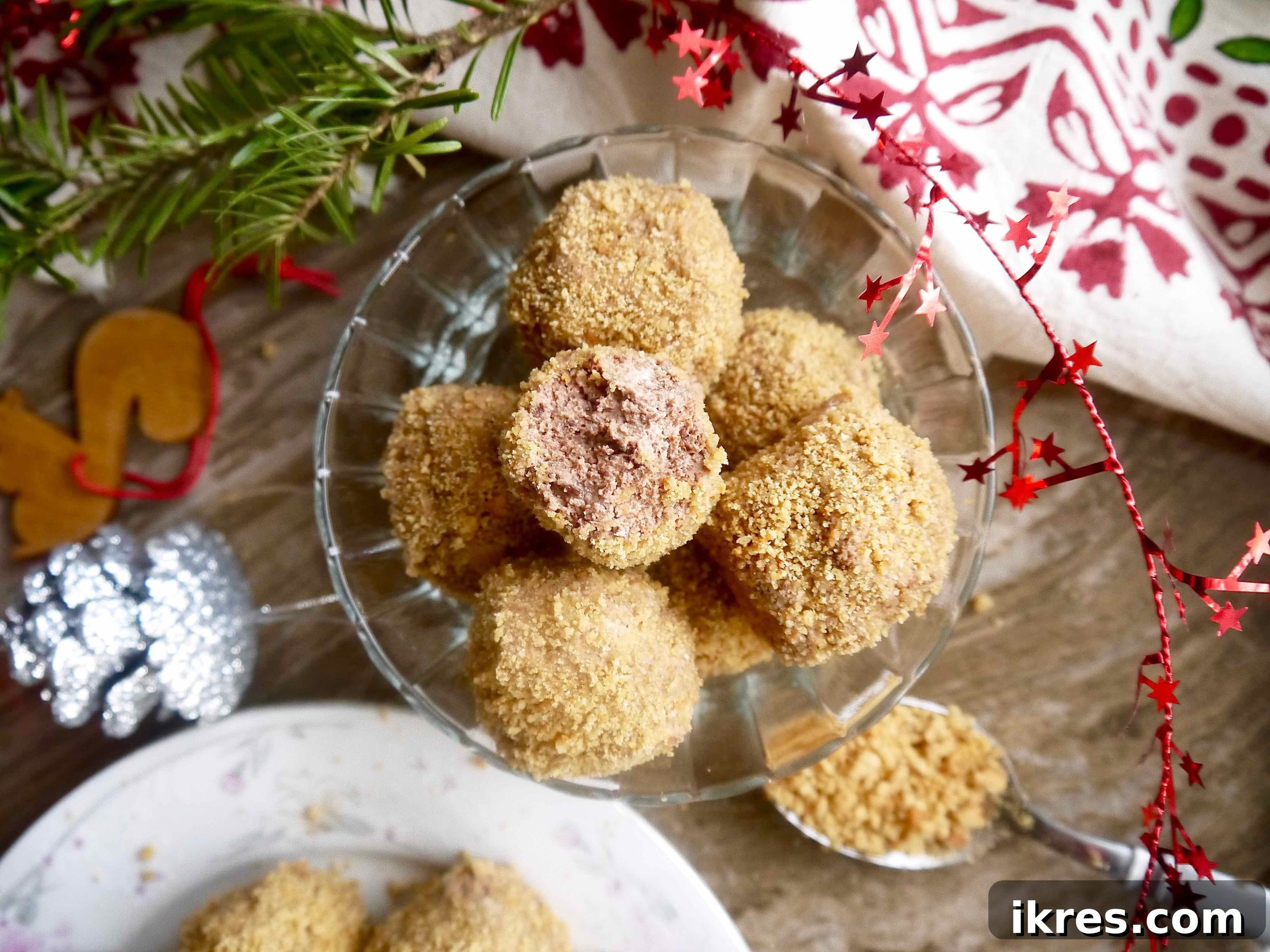 A Paleo Chocolate Mousse Truffle with a bite taken out, revealing its creamy chocolate interior and textured cookie crust.