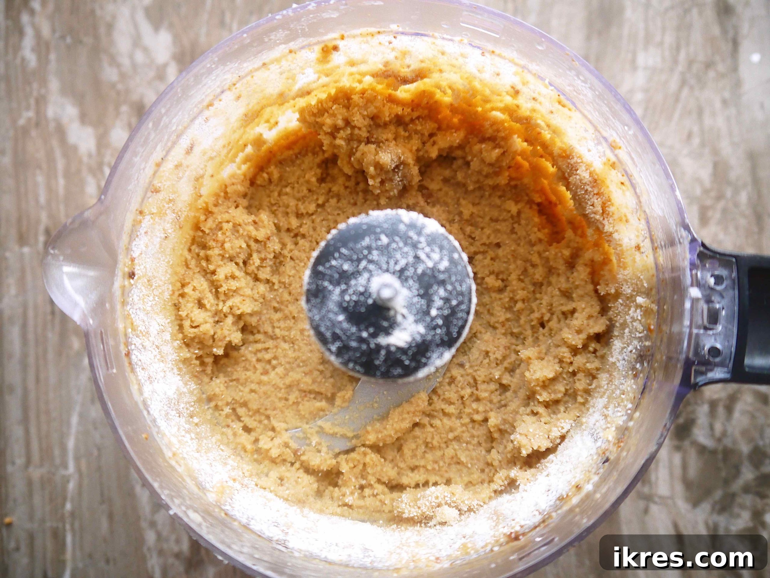 Paleo vanilla cookie dough being prepared in a food processor, ready for shaping.
