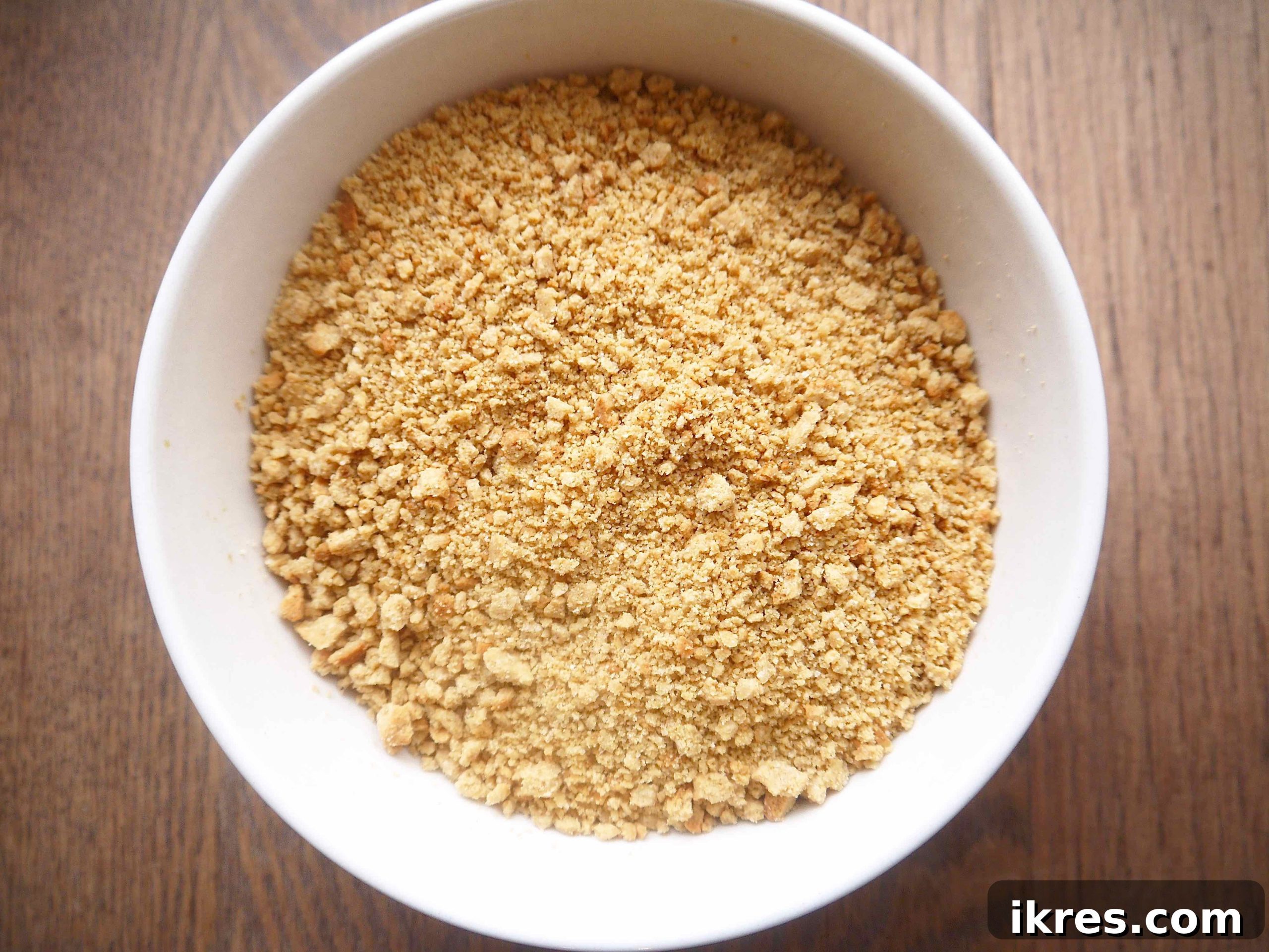 Cool Paleo vanilla cookies crushed into fine crumbs in a bowl, ready to coat the mousse truffles.
