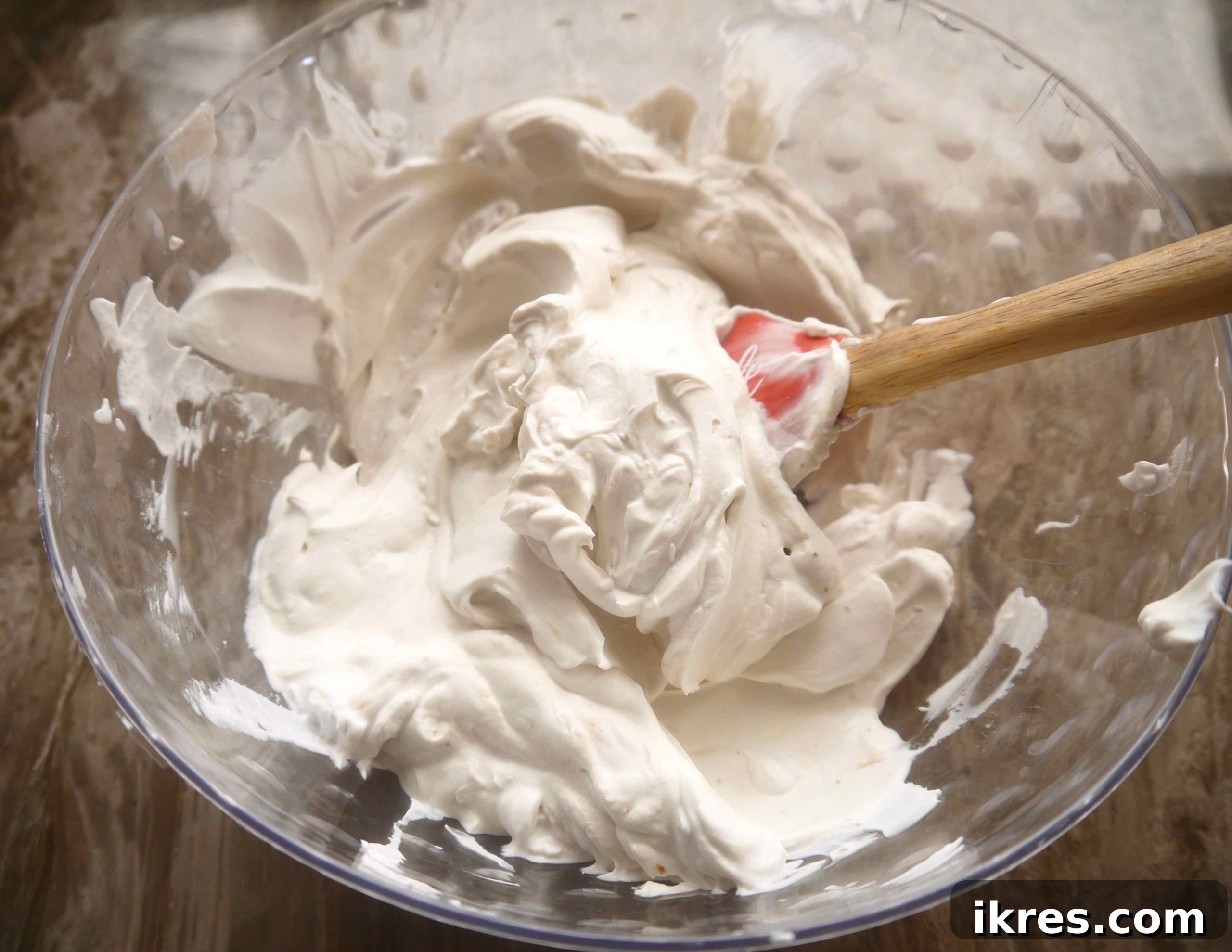 Thick, whipped coconut cream in a bowl, showing its light and airy texture.