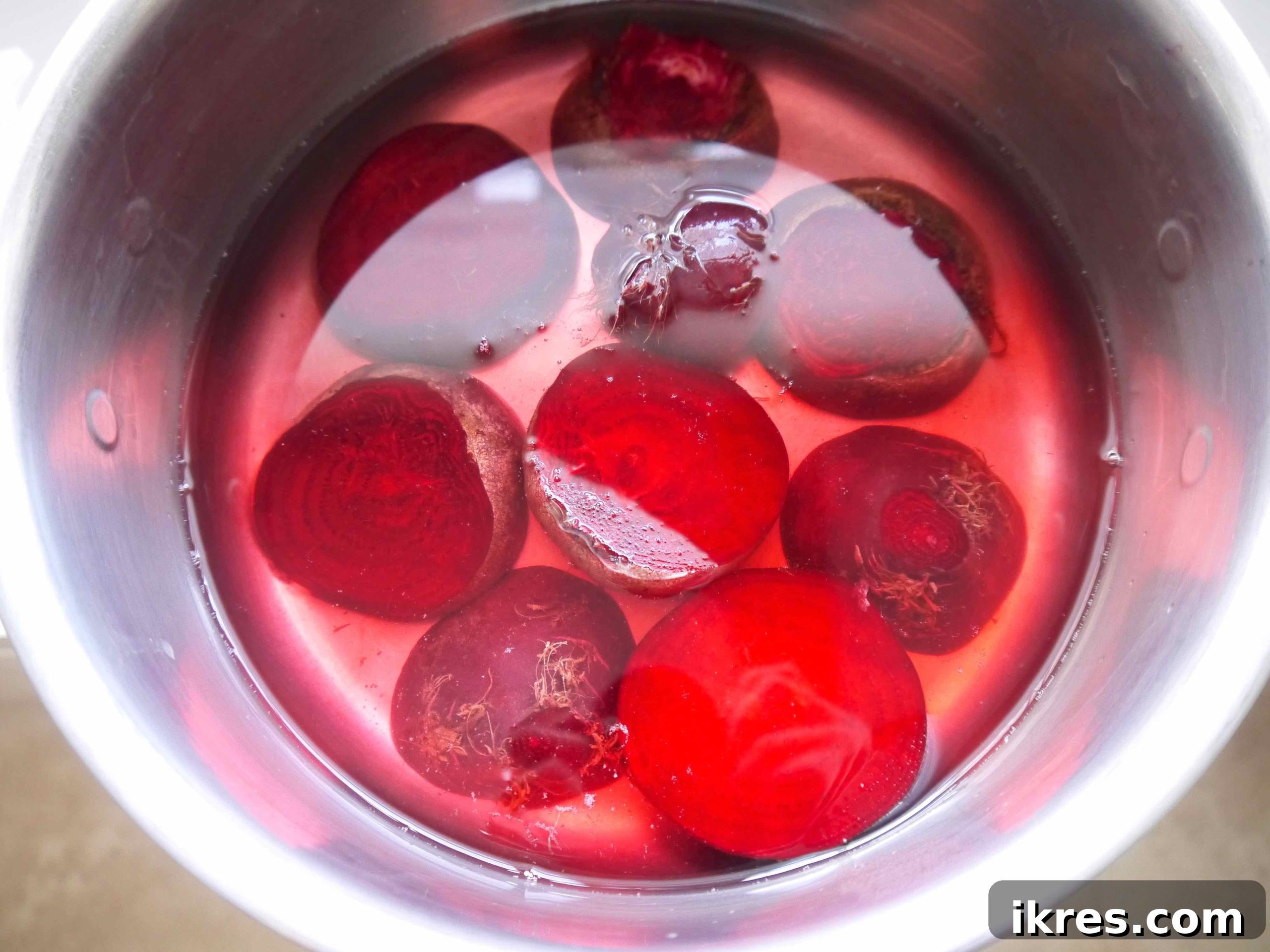 Vibrant Quinoa Beet Salad with Tuna 4 Sliced raw beets submerged in water in a cooking pot.