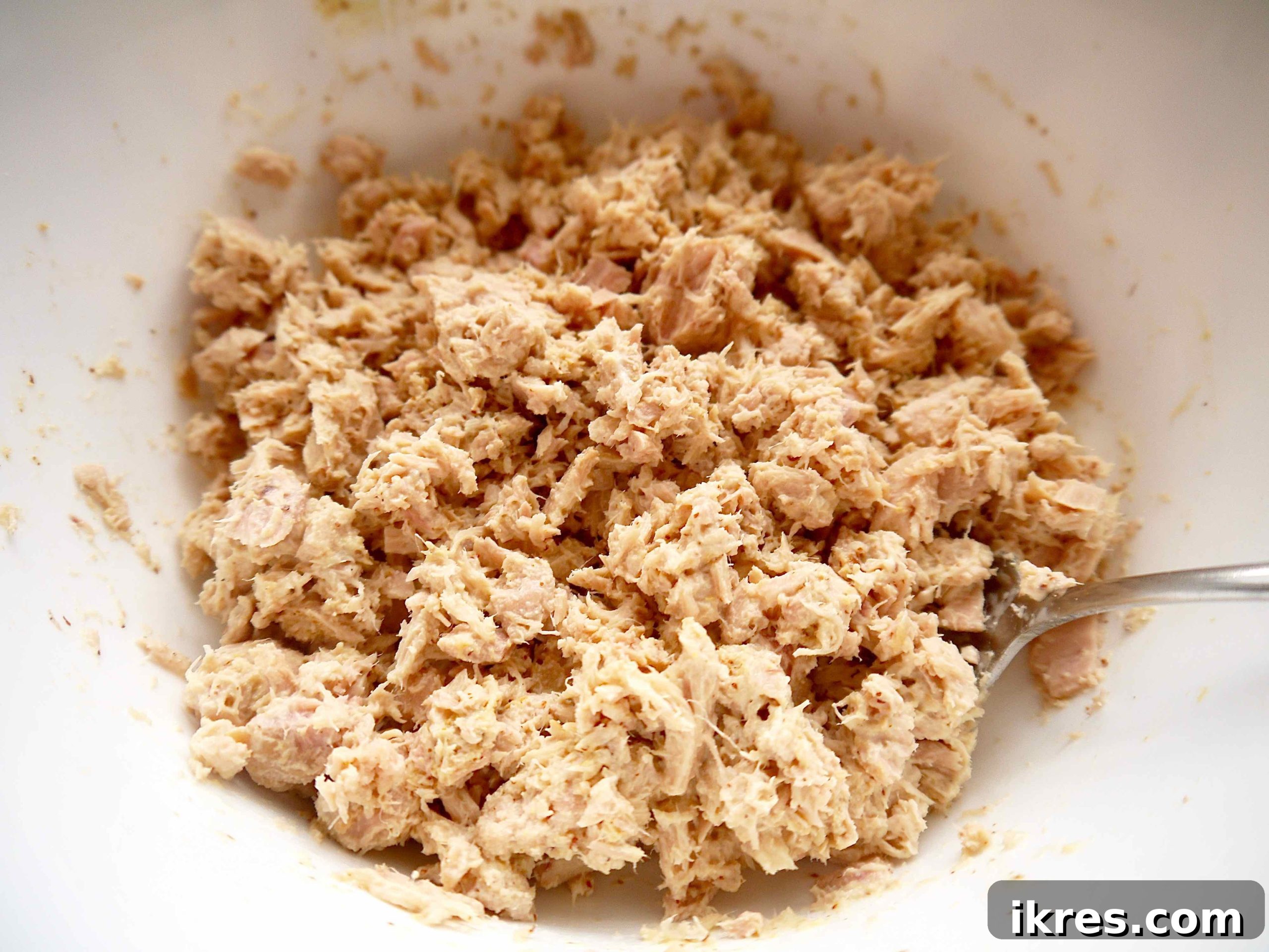 Vibrant Quinoa Beet Salad with Tuna 6 Canned tuna being mixed with mayonnaise and mustard in a large bowl.