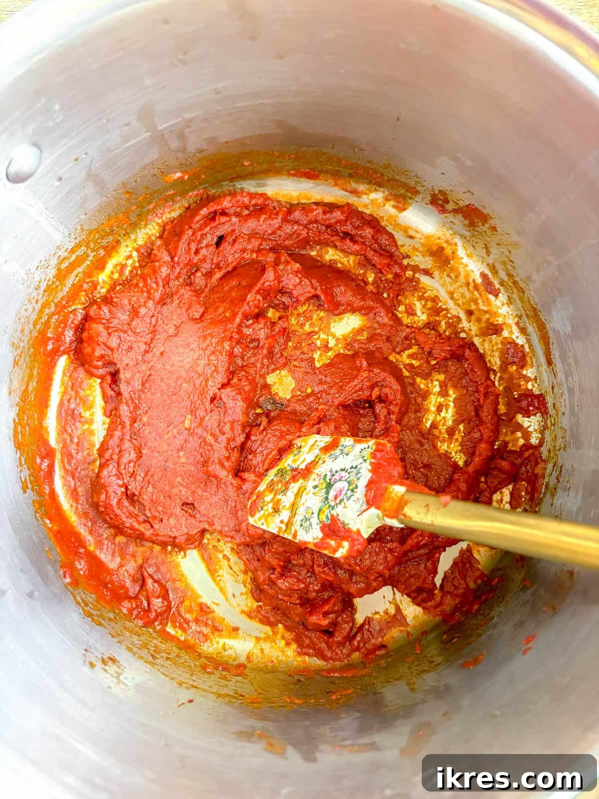 Creamy Vegan Vodka Sauce 6 Vodka being poured into the simmering tomato sauce mixture.