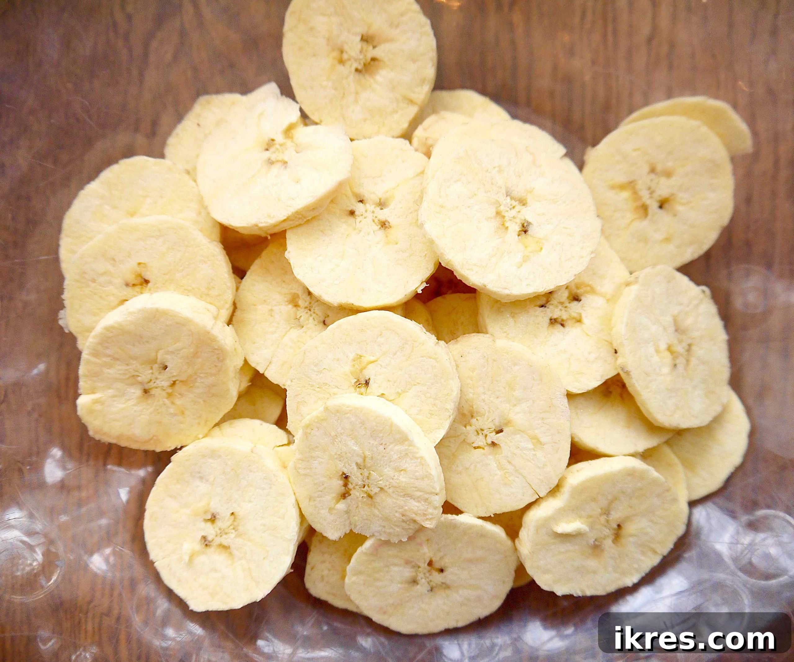 Close-up of thin plantain slices seasoned with paprika and garlic.