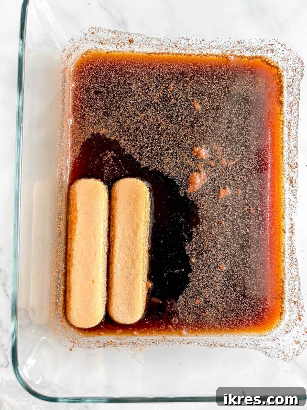 Lady fingers dunked into the coffee mixture.