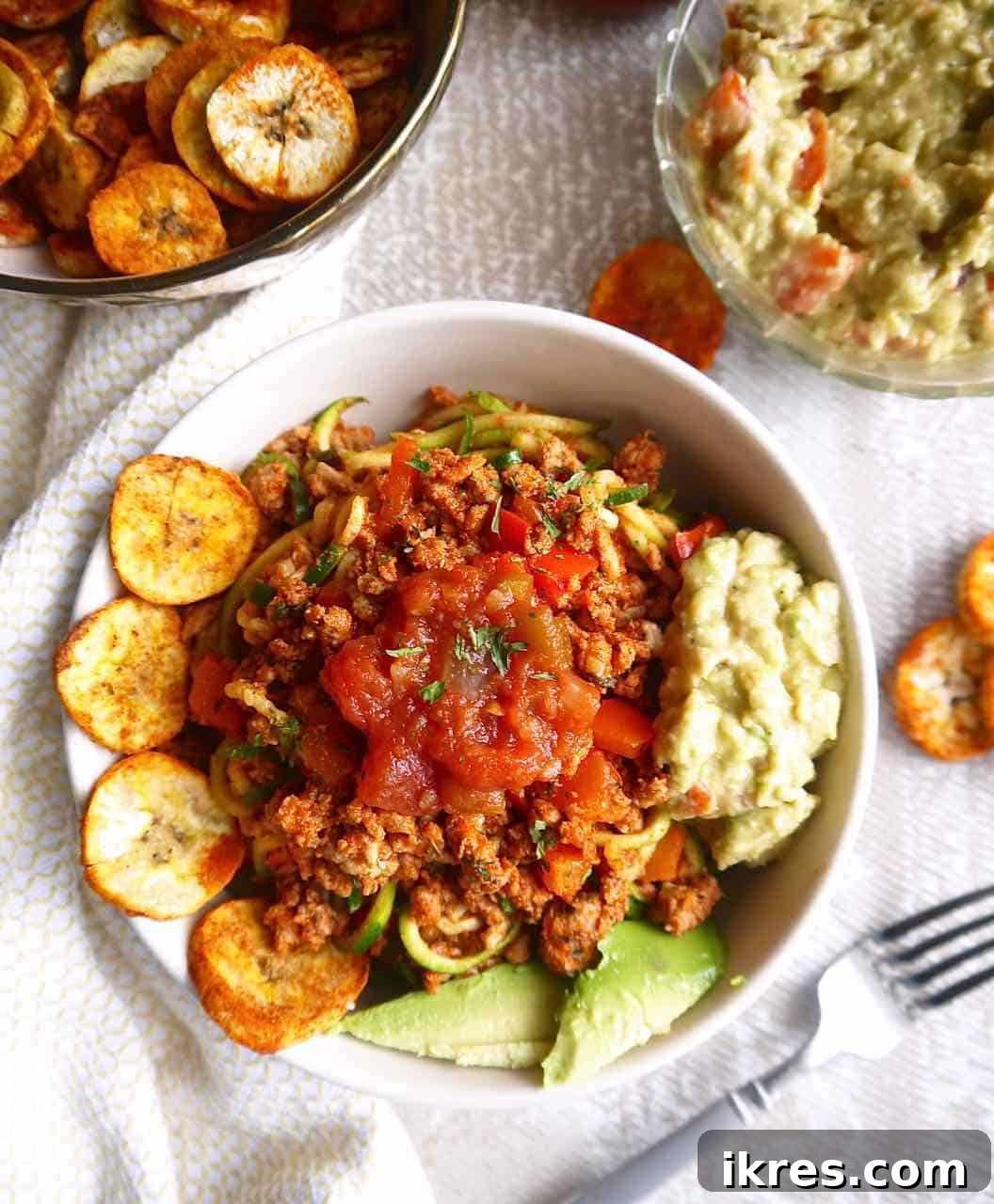 Zesty Turkey Taco Zoodle Bowls 2 A vibrant bowl of Ground Turkey Taco Zoodles, featuring spiralized zucchini noodles beneath a rich, seasoned ground turkey topping.