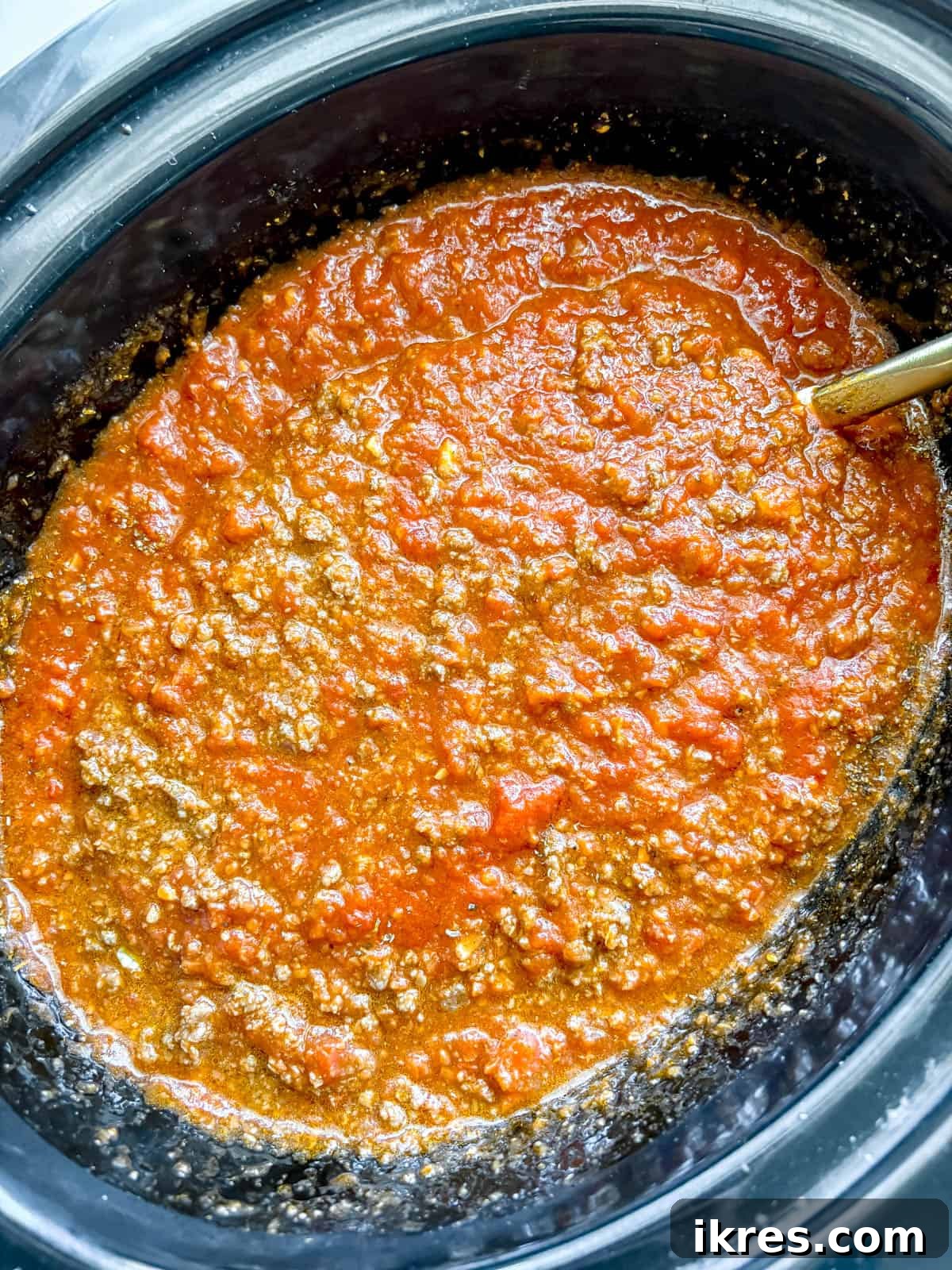 The slow cooker meat sauce thoroughly mixed before cooking.