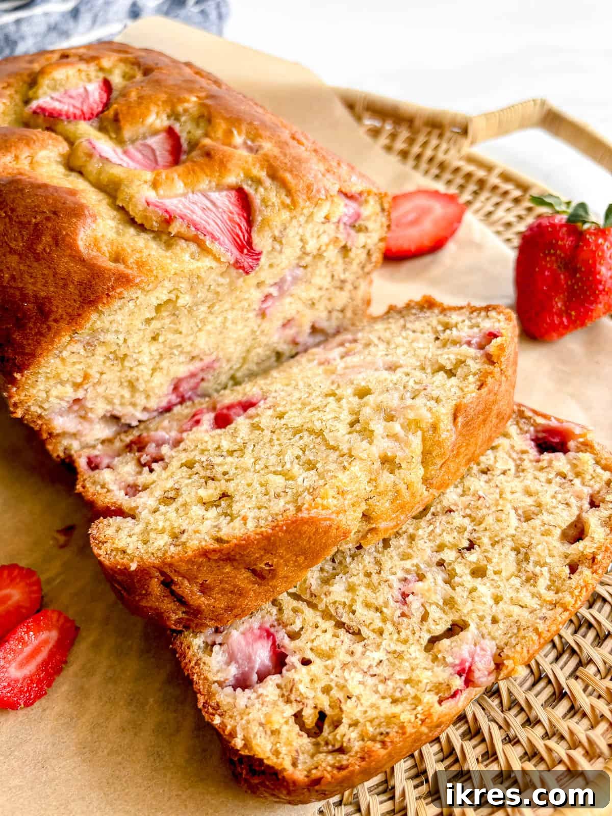Strawberry Swirl Banana Bread 2 Slices of fluffy strawberry banana bread adorned with fresh berries on a plate, ready to be enjoyed.