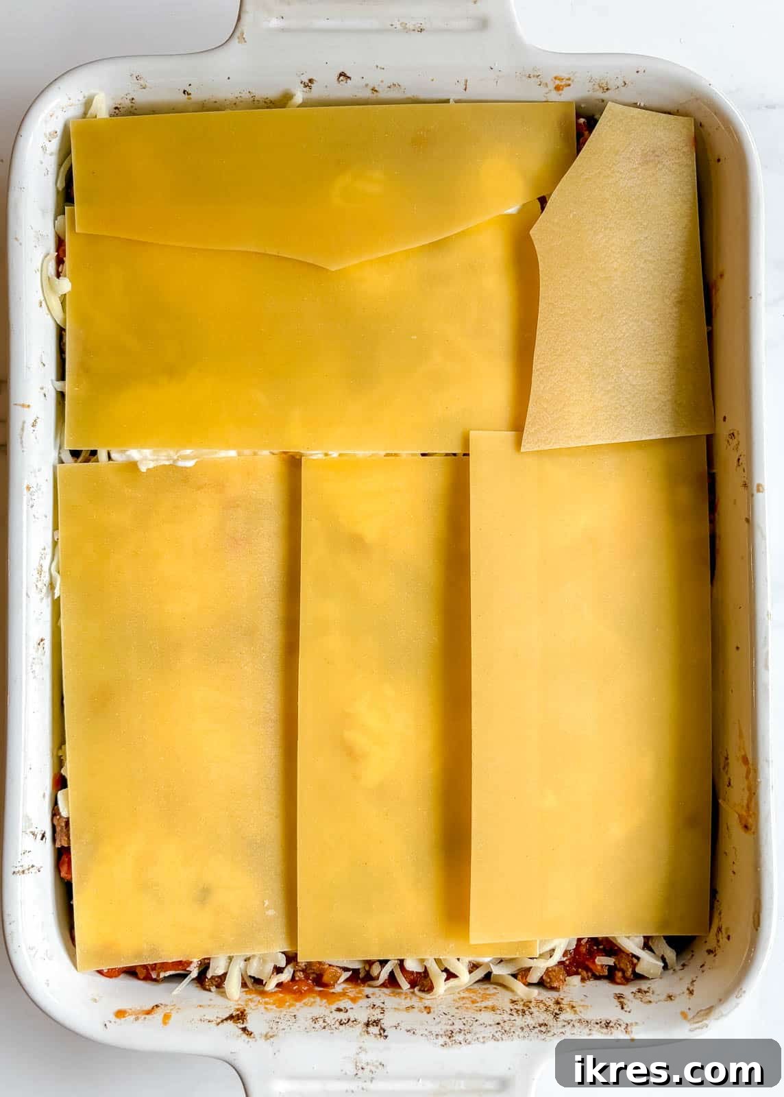 Effortless Greek Yogurt Lasagna 12 The final layer of no-boil noodles placed on the lasagna before the topping.