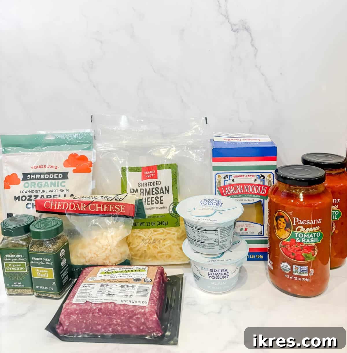 Effortless Greek Yogurt Lasagna 3 The essential ingredients for no-boil lasagna with Greek yogurt laid out on a countertop.