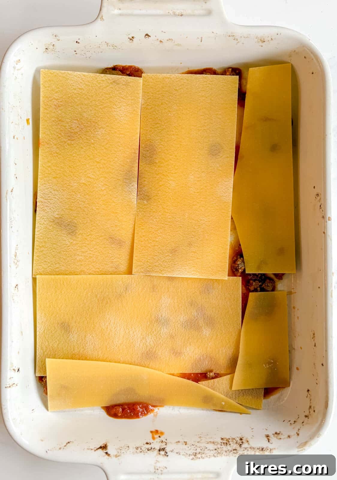 Effortless Greek Yogurt Lasagna 7 A layer of no-boil lasagna noodles placed over the meat sauce in the baking dish.