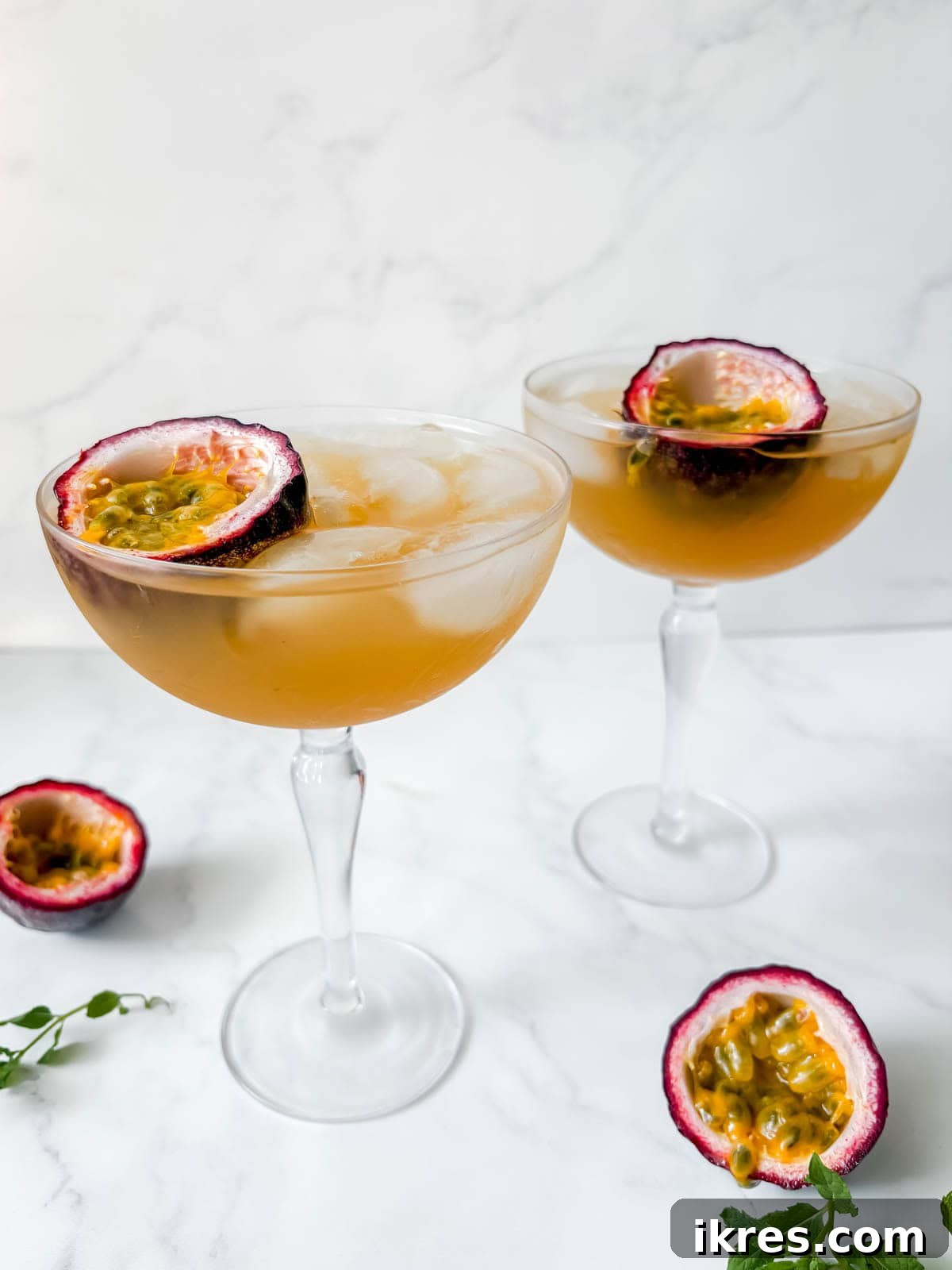 Passion fruit gin cocktails garnished with passion fruit.
