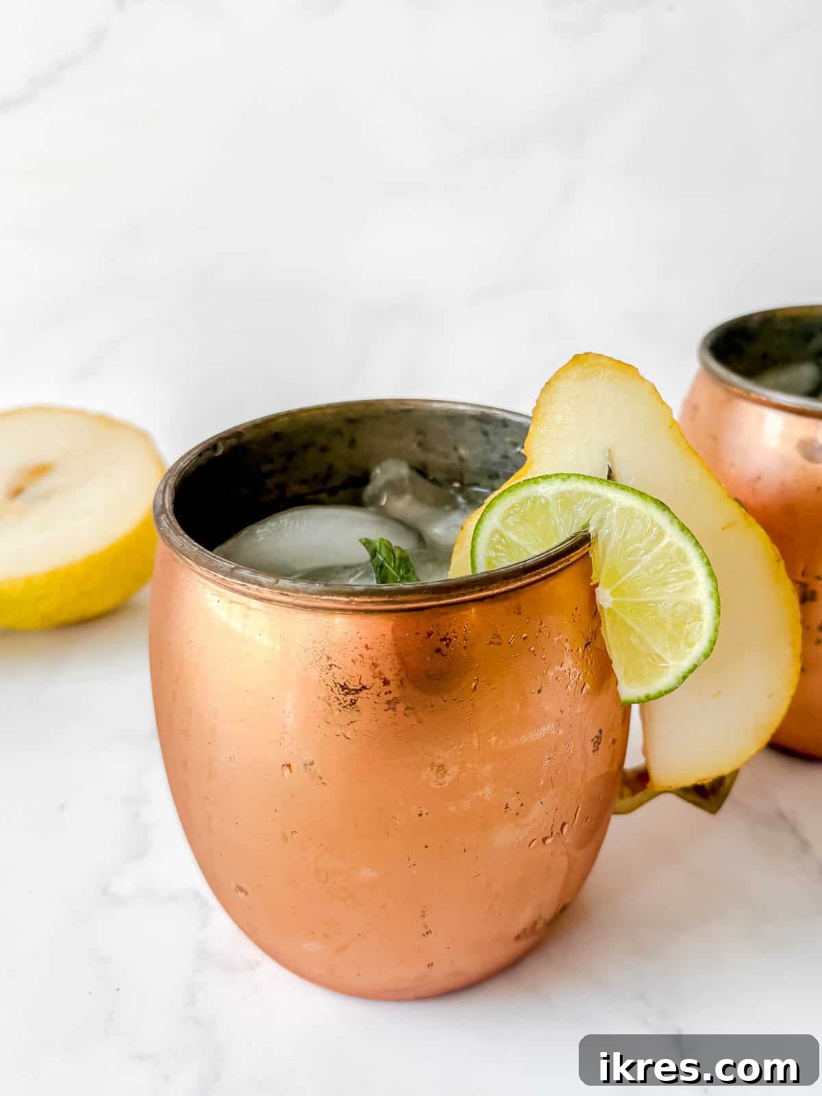Pear Vodka Moscow Mule: Refreshing Pear Cocktail 6 Pear cocktail poured into a cup filled with ice.