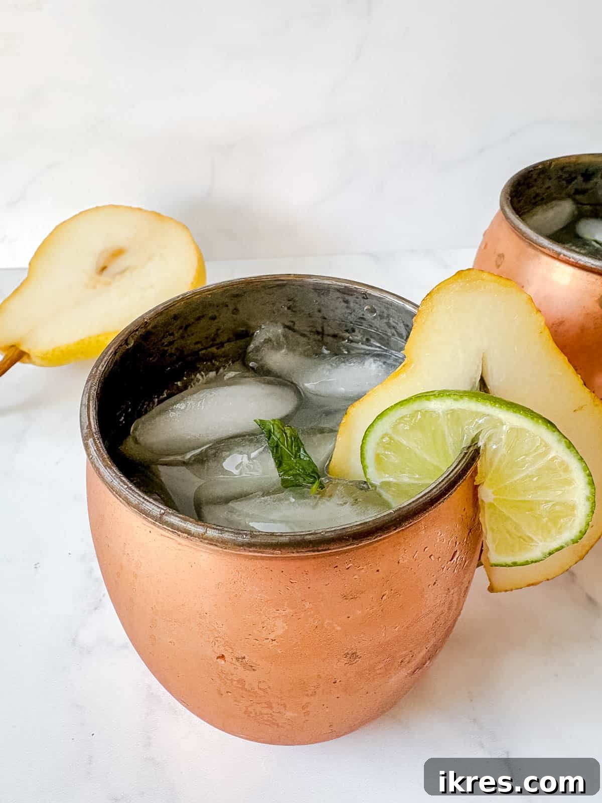 Pear Vodka Moscow Mule: Refreshing Pear Cocktail 7 A fresh zesty pear gingerbeer cocktail in a moscow mule copper cup.