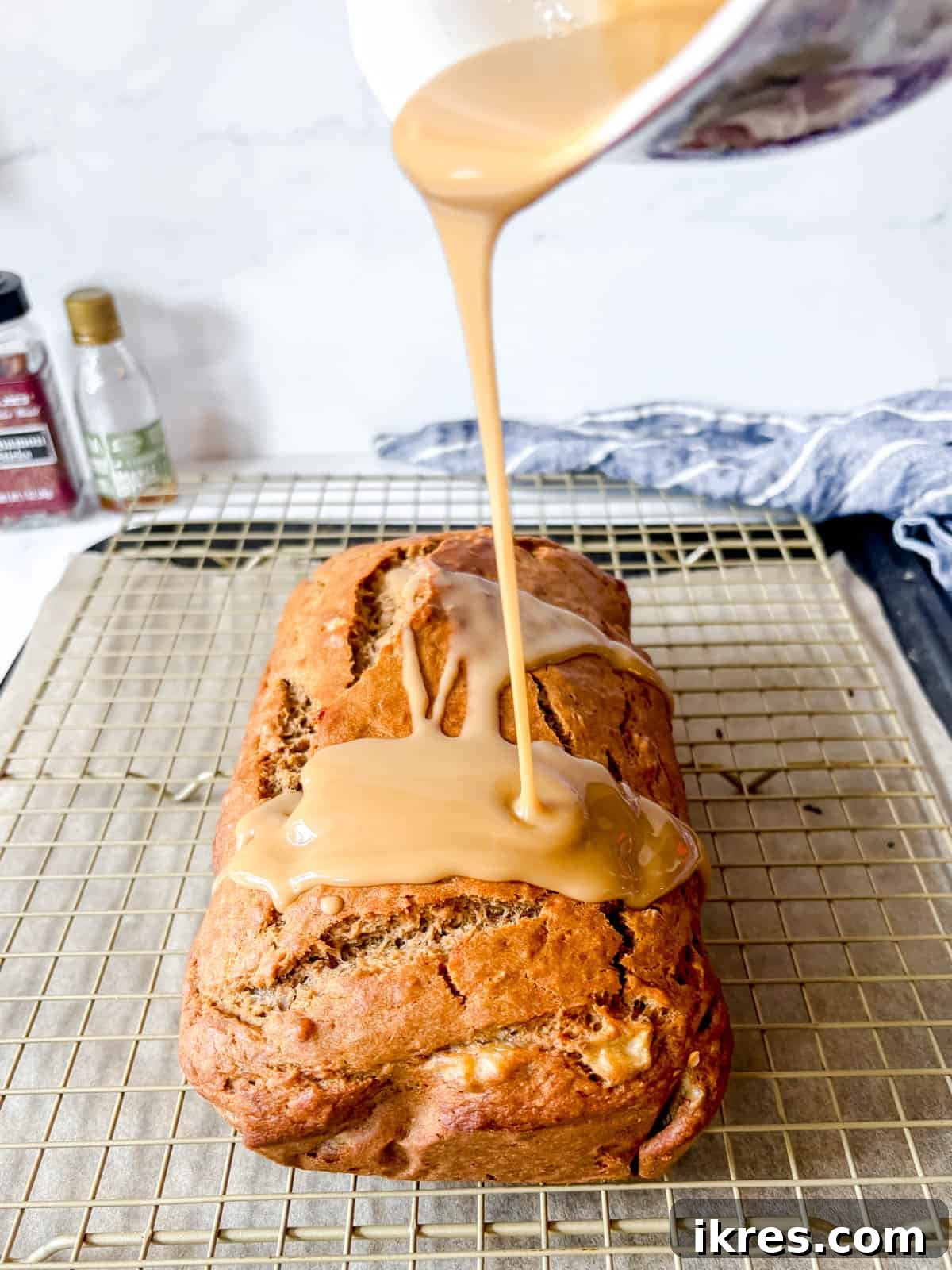 Maple glaze drizzled over banana bread.