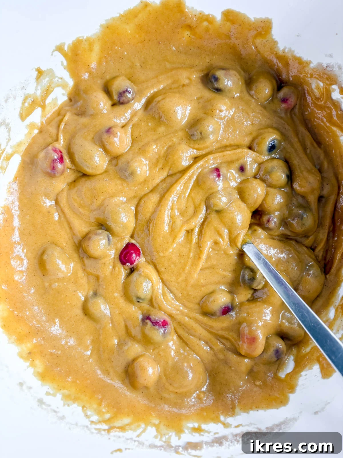 Pumpkin Cranberry Muffins Recipe: Spiced, Moist Fall Treats 7 Pumpkin cranberry batter in a bowl.